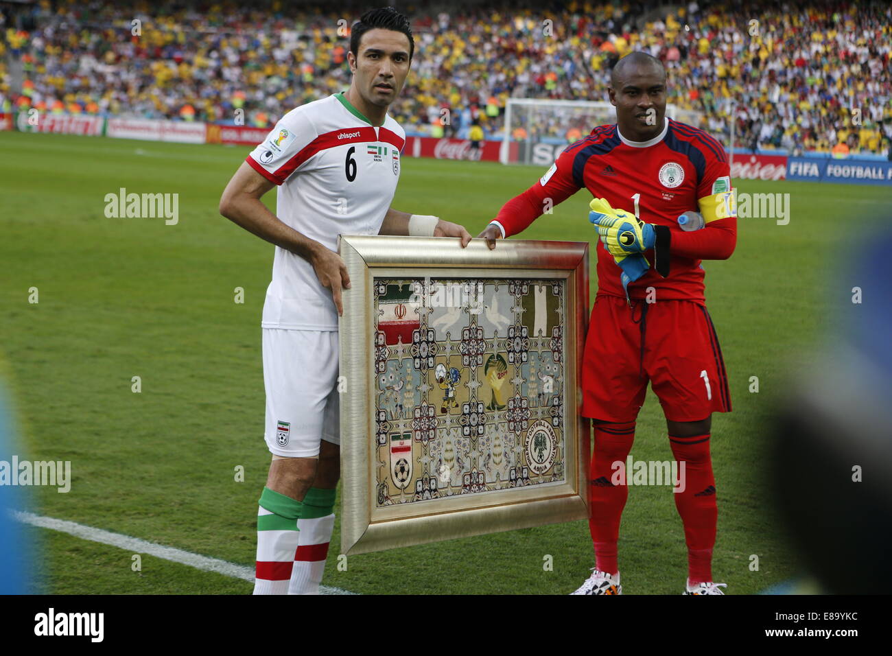 Javad Nekounam of Iran and Vincent Enyeama of Nigeria. Iran v Nigeria, group match. FIFA World Cup Brazil 2014. Arena da Baixada Stock Photo