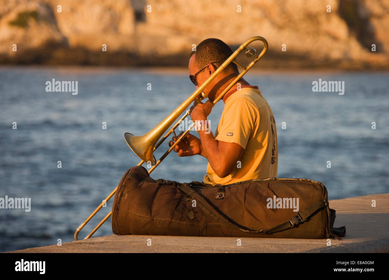 Musician playing the trombone at the Malecón esplanade, Havana, Cuba