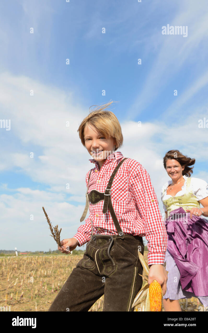 Mother and son running in cornfield, Bavaria, Germany Stock Photo