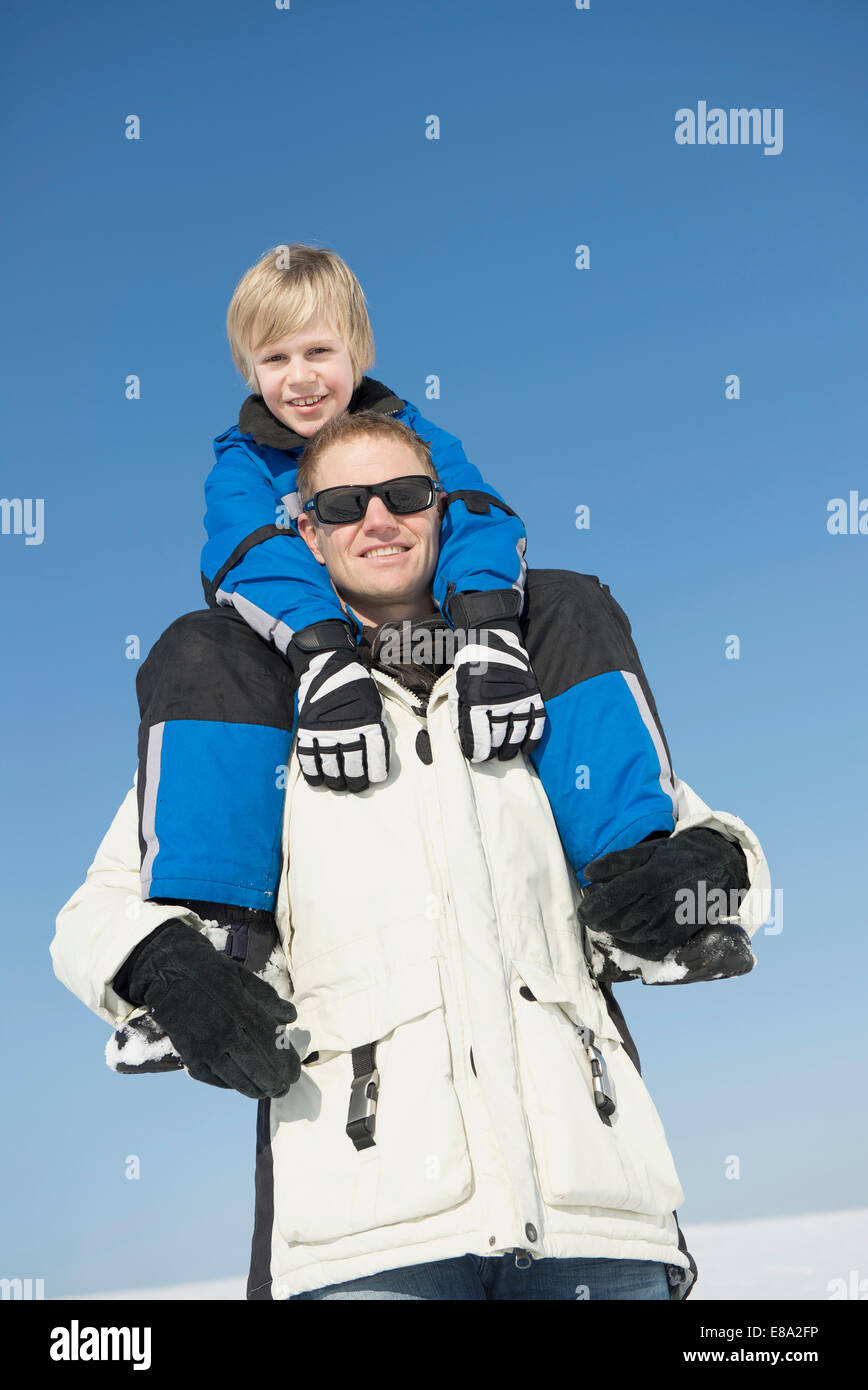 Father carrying son on shoulder, smiling, Bavaria, Germany Stock Photo