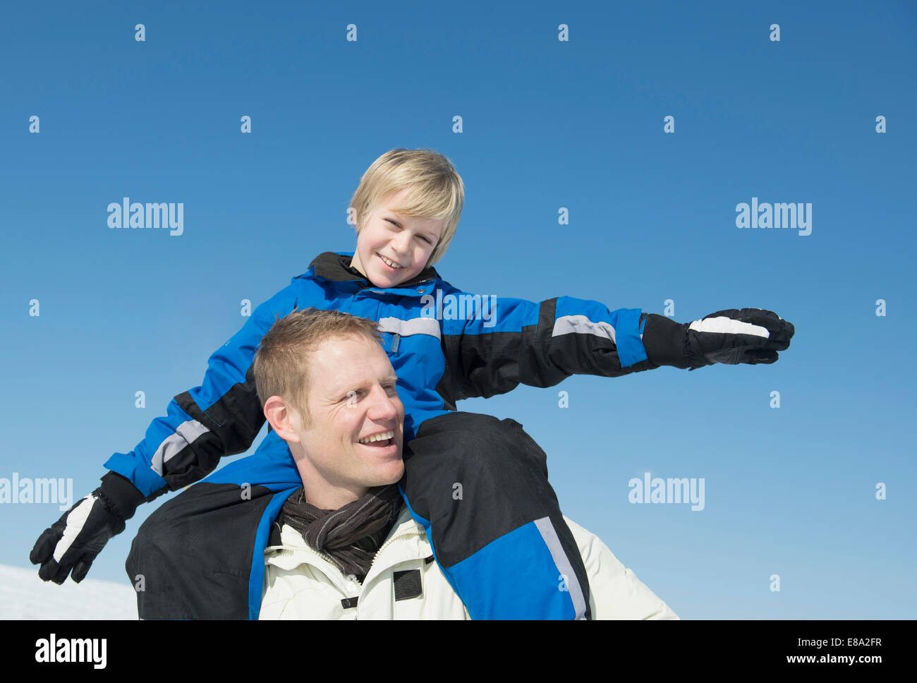Father carrying son on shoulder, smiling, Bavaria, Germany Stock Photo