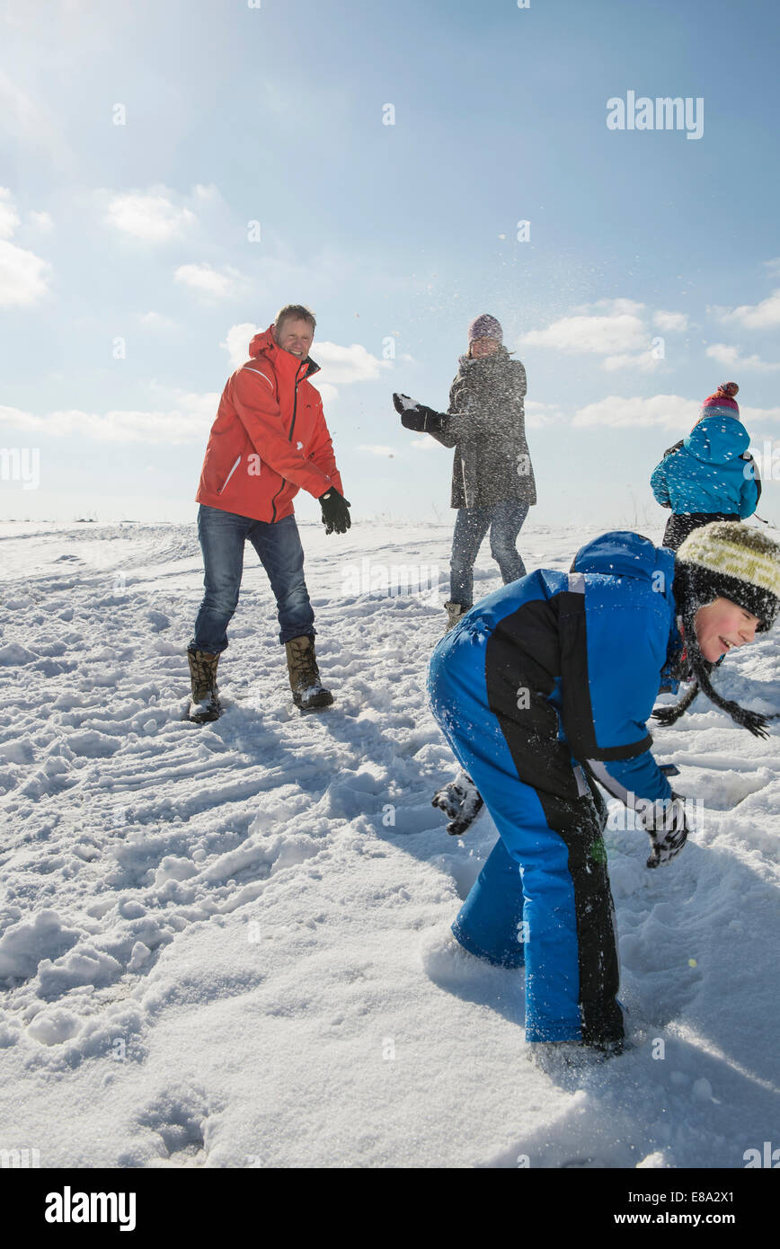 Family having snowball fight, smiling, Bavaria, Germany Stock Photo