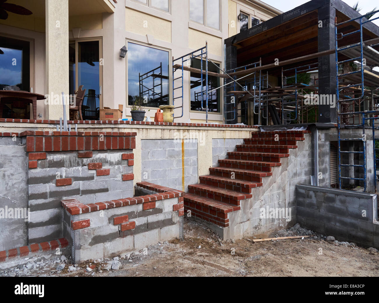 Decorative brickwork, new brick stairs, and scaffolding on a construction project. Stock Photo