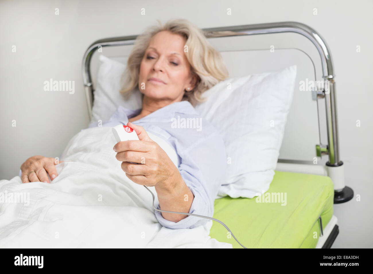 Patient in hospital ringing for nurse Stock Photo