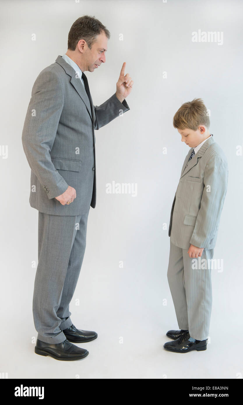 Father blusters his son against white background Stock Photo