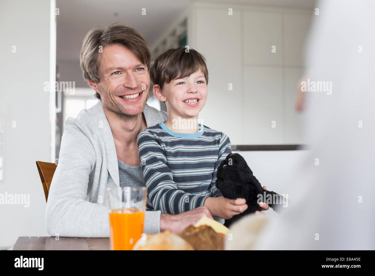 Family at breakfast table, smiling Stock Photo - Alamy