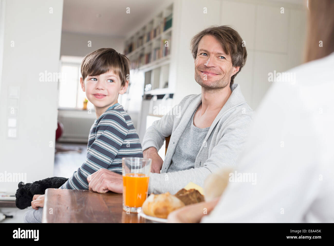 Family at breakfast table, smiling Stock Photo - Alamy