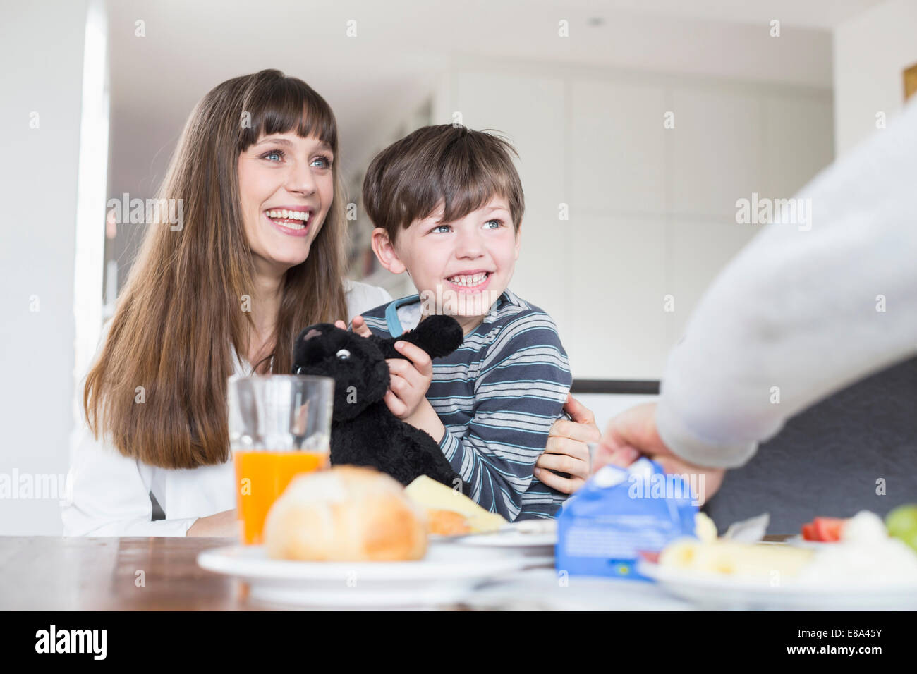 Family at breakfast table, smiling Stock Photo - Alamy