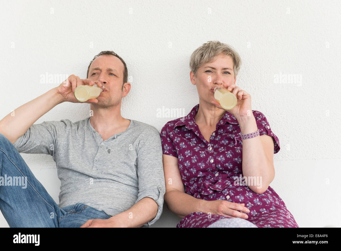 Mature couple drinking drink from bottle Stock Photo