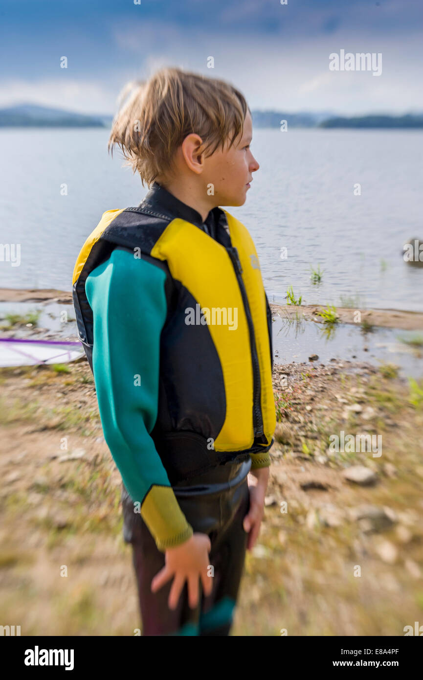 boy in wet suit and life jacket vest Stock Photo
