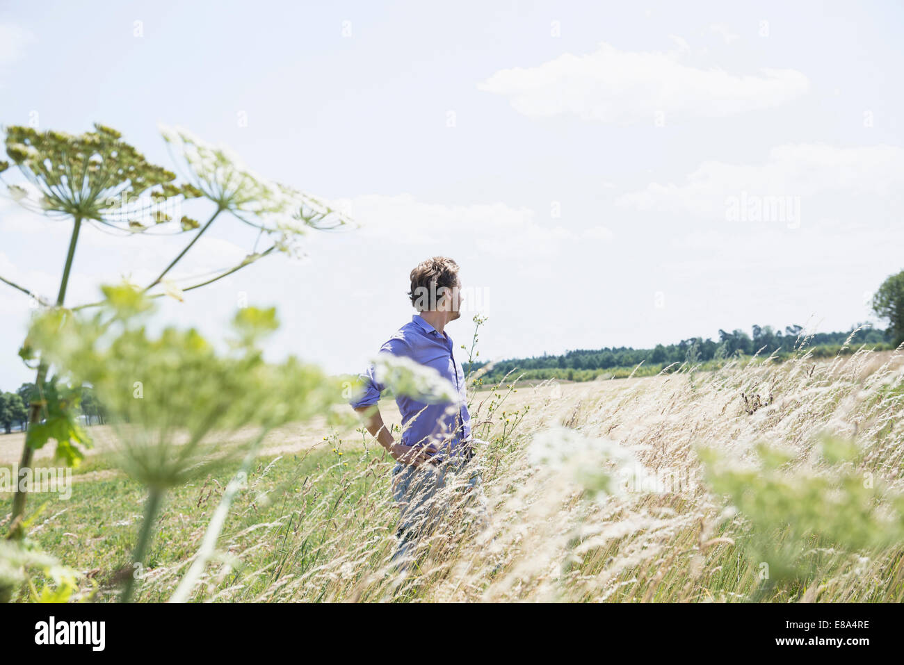 Mid adult man standing hi-res stock photography and images - Alamy