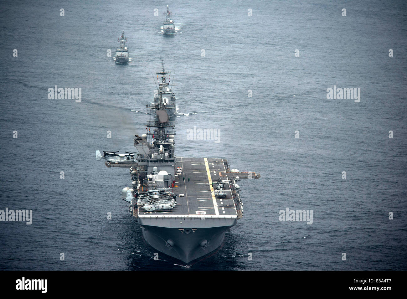 The amphibious assault ship USS America (LHA 6), front, and Peruvian Navy ships sail in formation during a passing exercise in the Pacific Ocean Sept. 3, 2014. The America embarked on a mission to conduct training engagements with partner nations througho Stock Photo