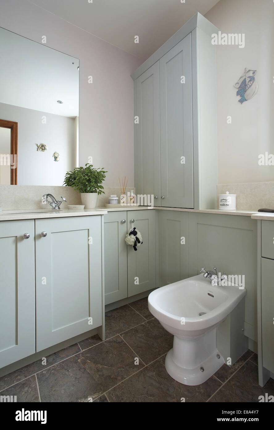 Bathroom interior in a home in the UK in a pastel blue - green color. Stock Photo