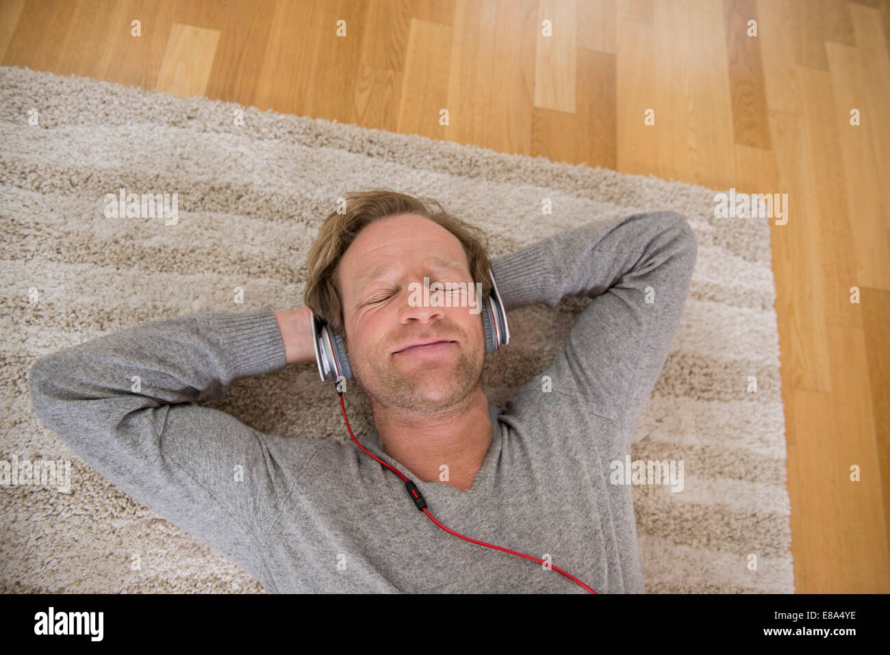Listening Rug Men lying on rug hi-res stock photography and images - Alamy