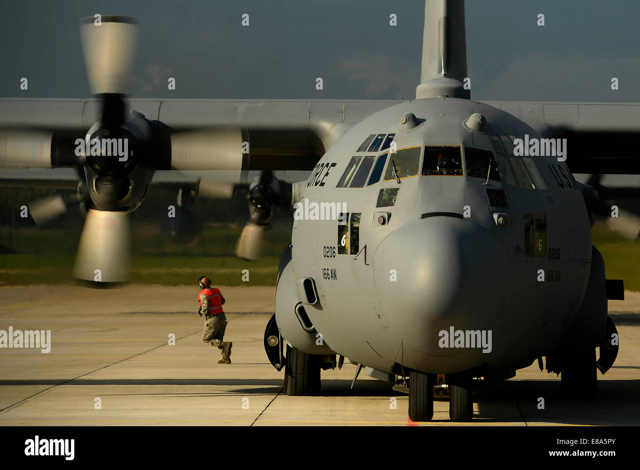 A U.S. Air Force C-130H Hercules aircraft assigned to the 142nd Airlift Squadron, Delaware Air National Guard is on the flight line at Lielvarde Air Base, Latvia, as U.S. Soldiers assigned to the 173rd Airborne Brigade Combat Team prepare to depart from t Stock Photo