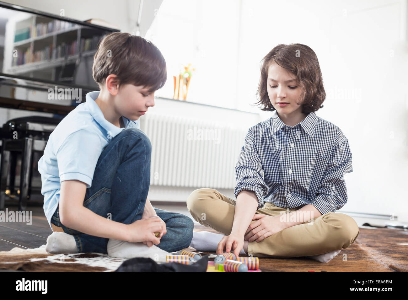 Girl and boy playing board game Stock Photo