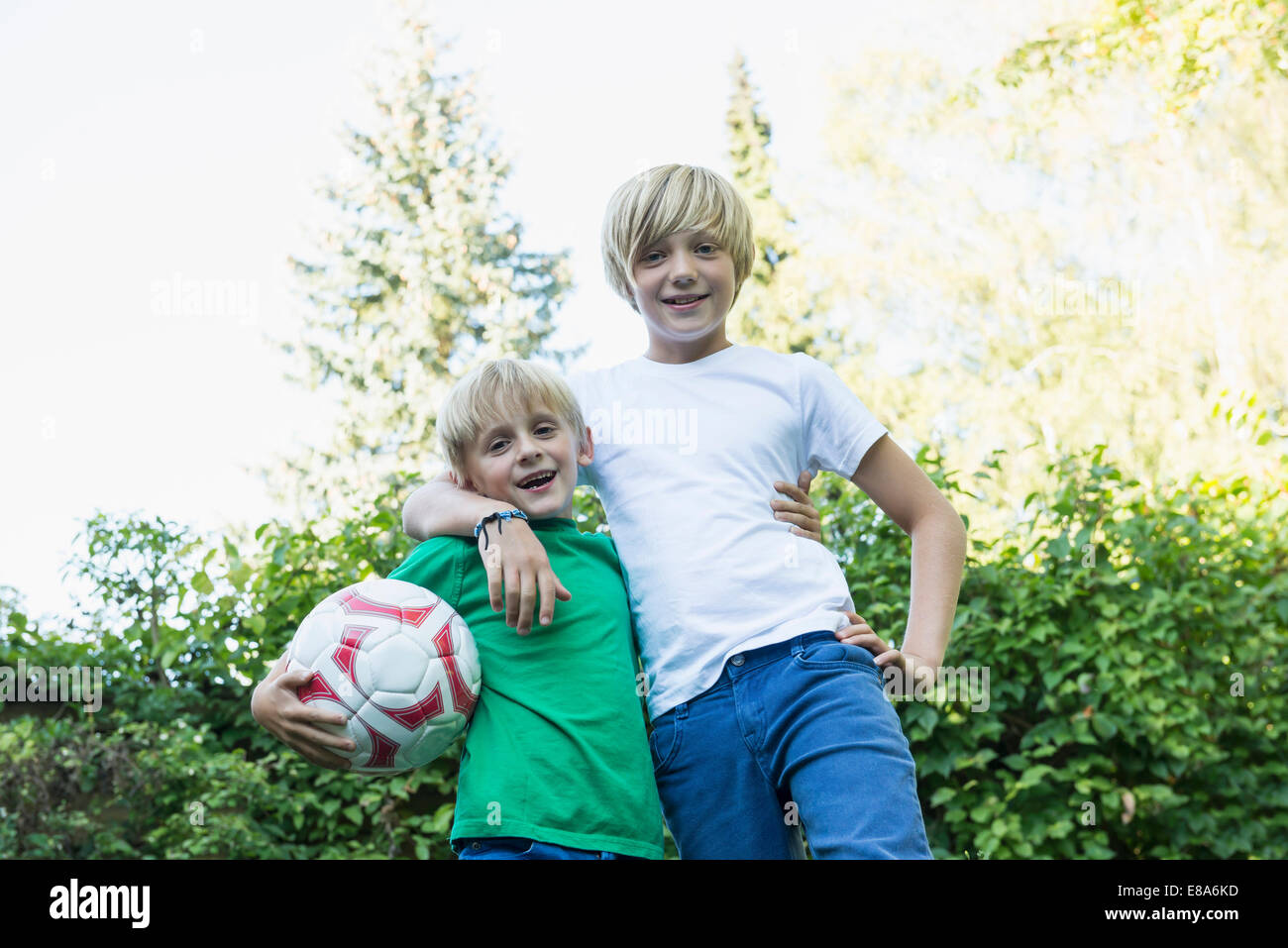 Two brothers arm in arm in the garden Stock Photo Alamy