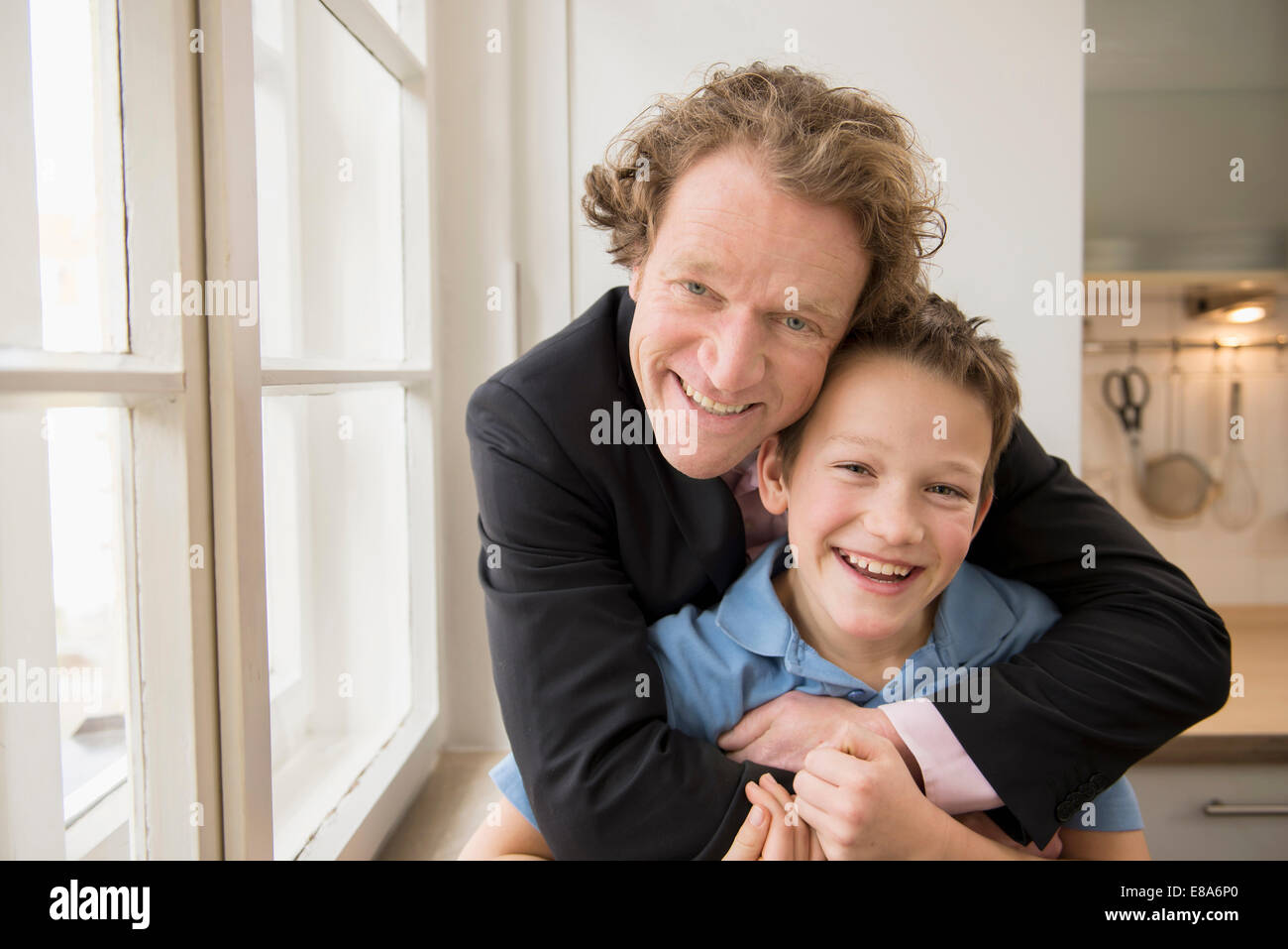 Portrait of father in suit hugging son Stock Photo - Alamy