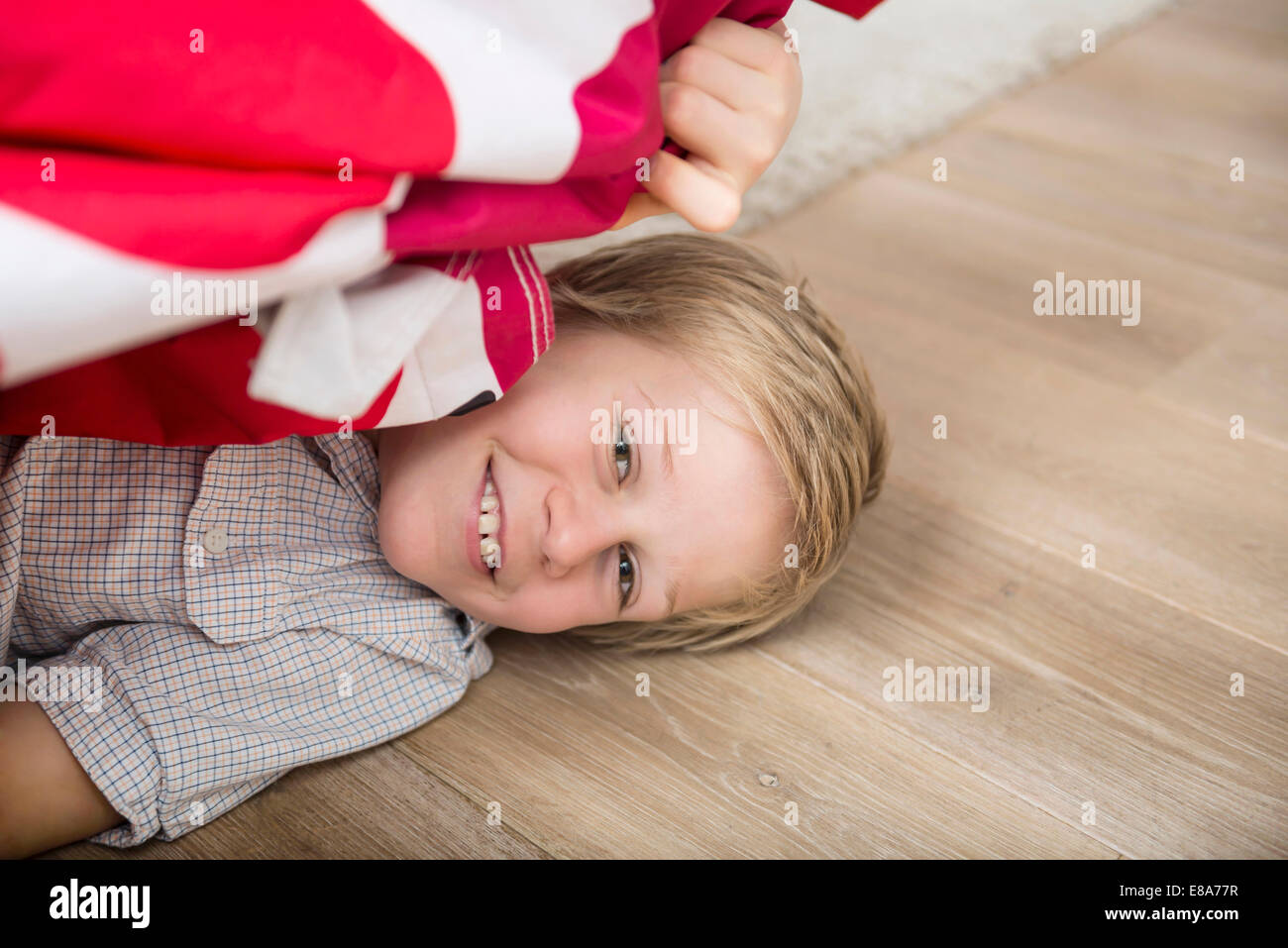 Boy hiding under bed Stock Photo - Alamy