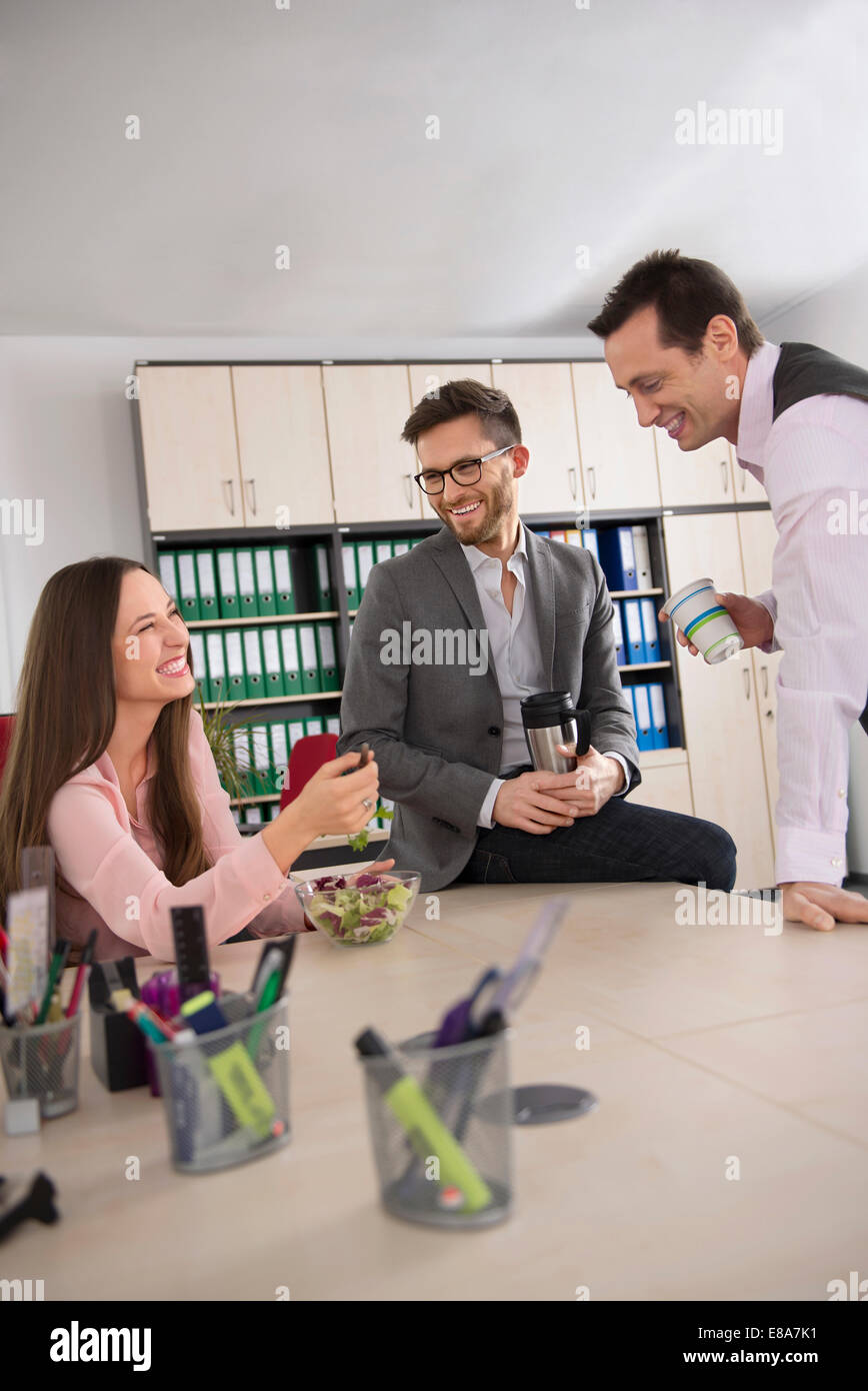 Three young business partners coffee break office Stock Photo - Alamy