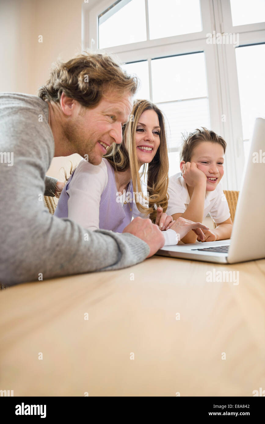 Family using laptop at home Stock Photo - Alamy