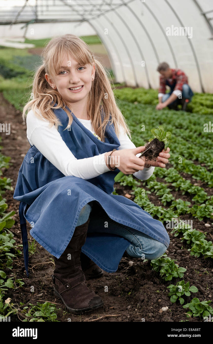 Smiling blond girl in greenhouse Stock Photo - Alamy