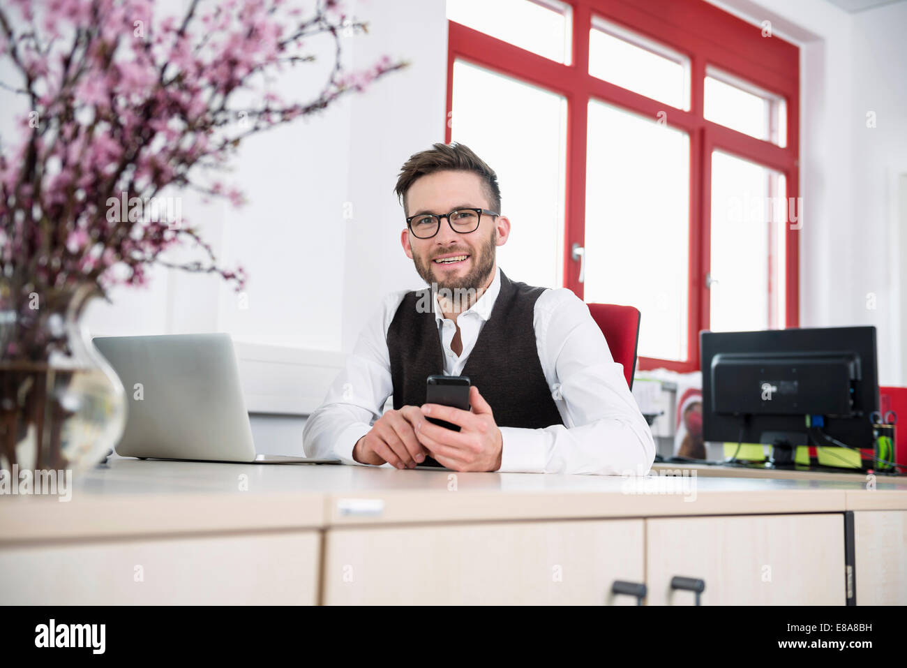 Young man office desk using Smartphone Stock Photo Alamy