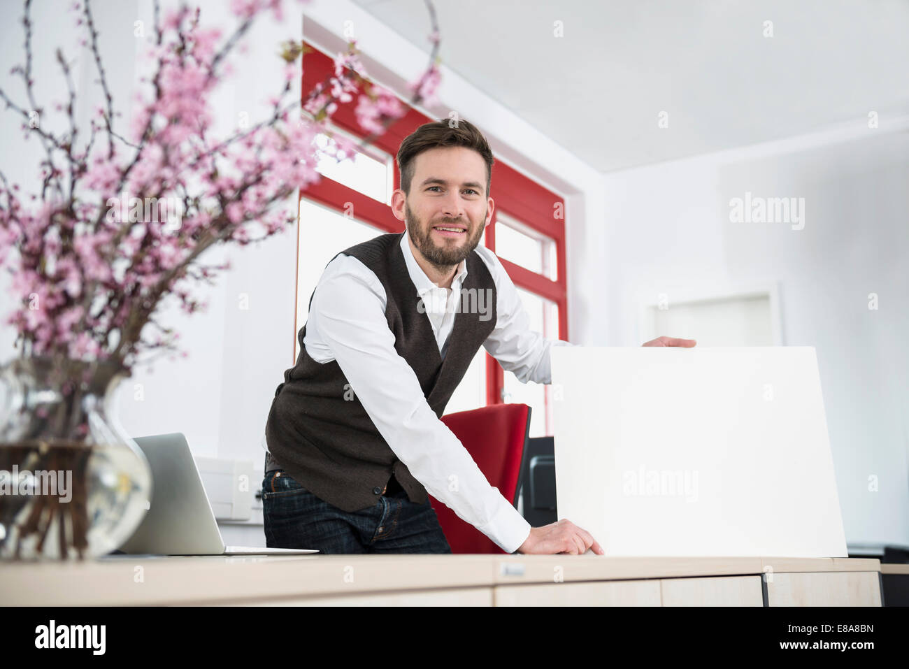 Young man office holding poster sign advert Stock Photo Alamy