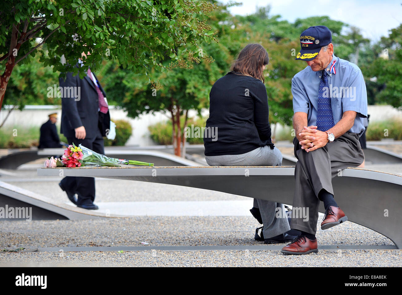 Herb Wolk (right) and his daughter, Devora Kirschner, reflect while sitting on a bench that serves as a memorial for Navy Lt. Darin Pontell before the 9/11 memorial ceremony at the Pentagon in Washington, Sept. 11, 2014. Kirschner was married to Pontell w Stock Photo
