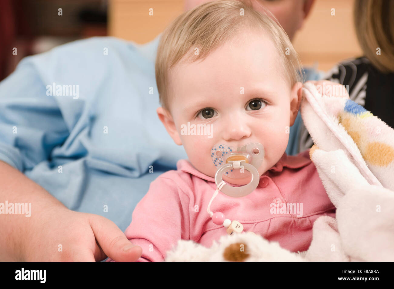 Portrait of baby girl with dummy in father arms Stock Photo Alamy