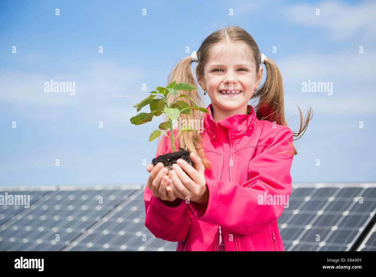 Girl holding plant environmental protection Stock Photo Alamy
