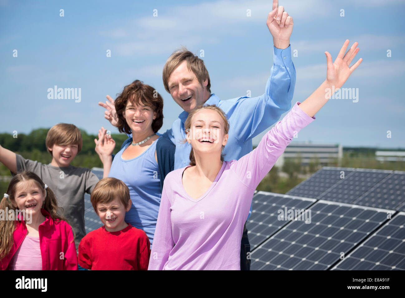 Large family parents four kids solar energy park Stock Photo