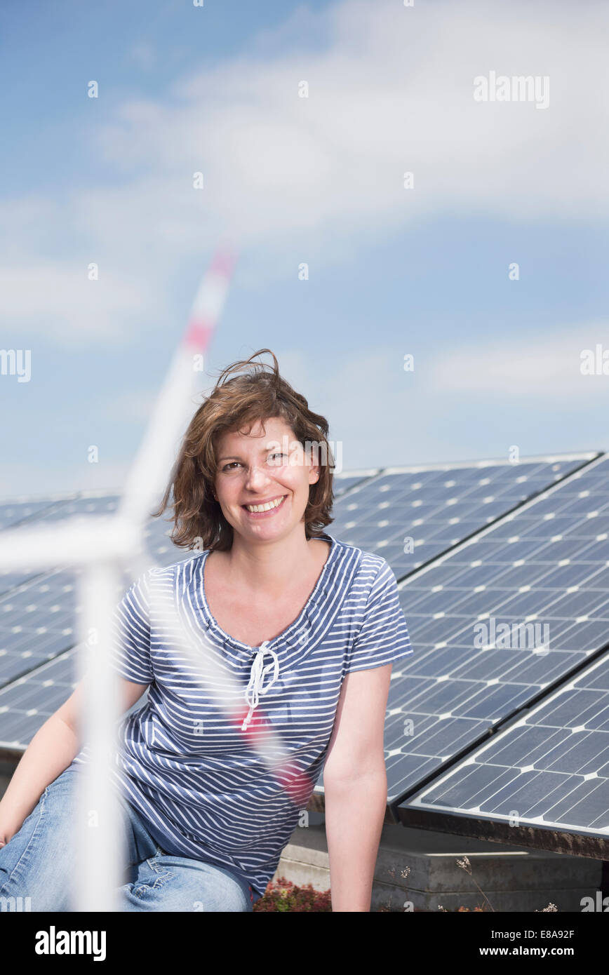 Portrait young woman solar panel wind turbine Stock Photo - Alamy