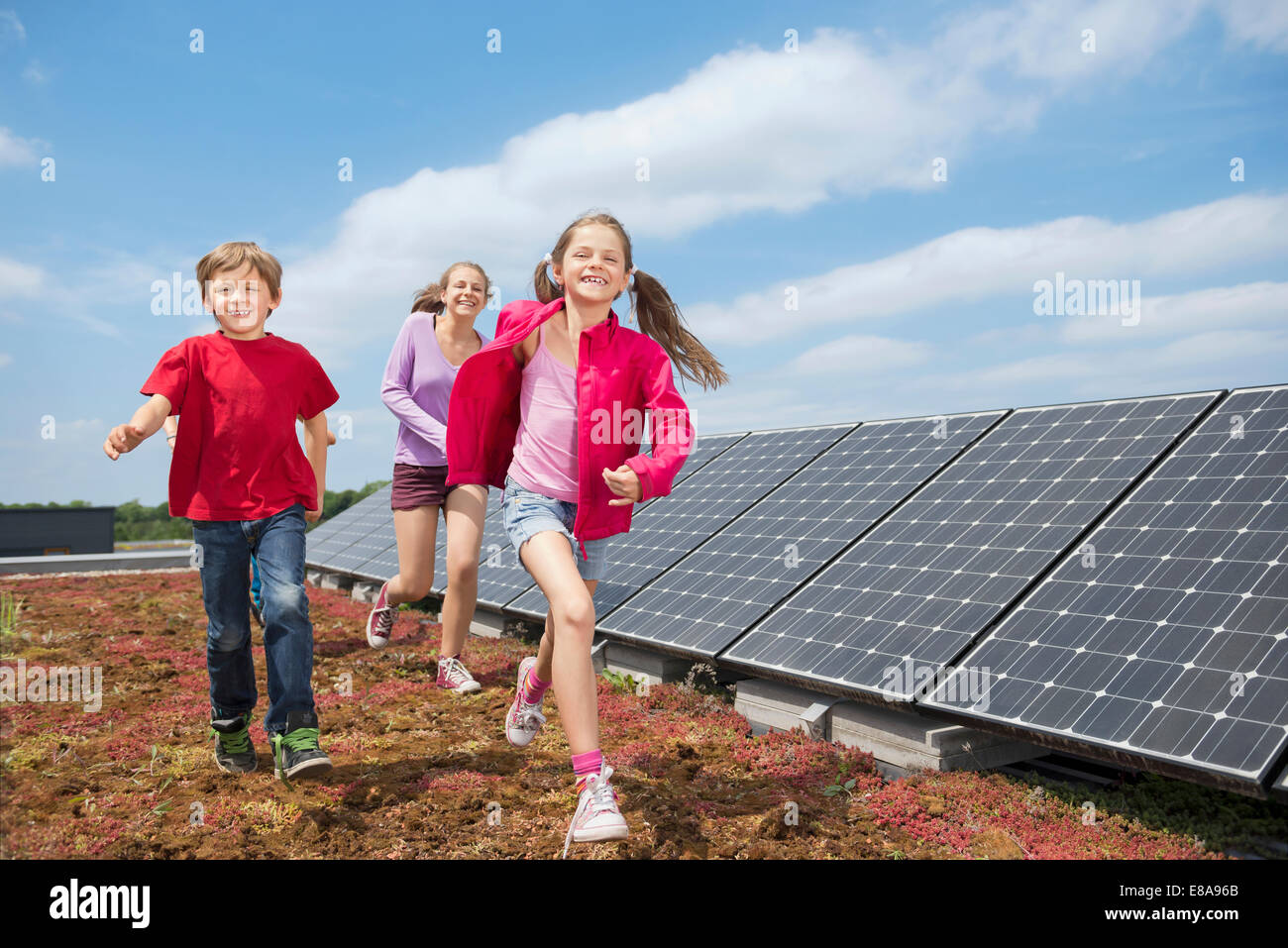 Brother sisters running sport solar energy Stock Photo
