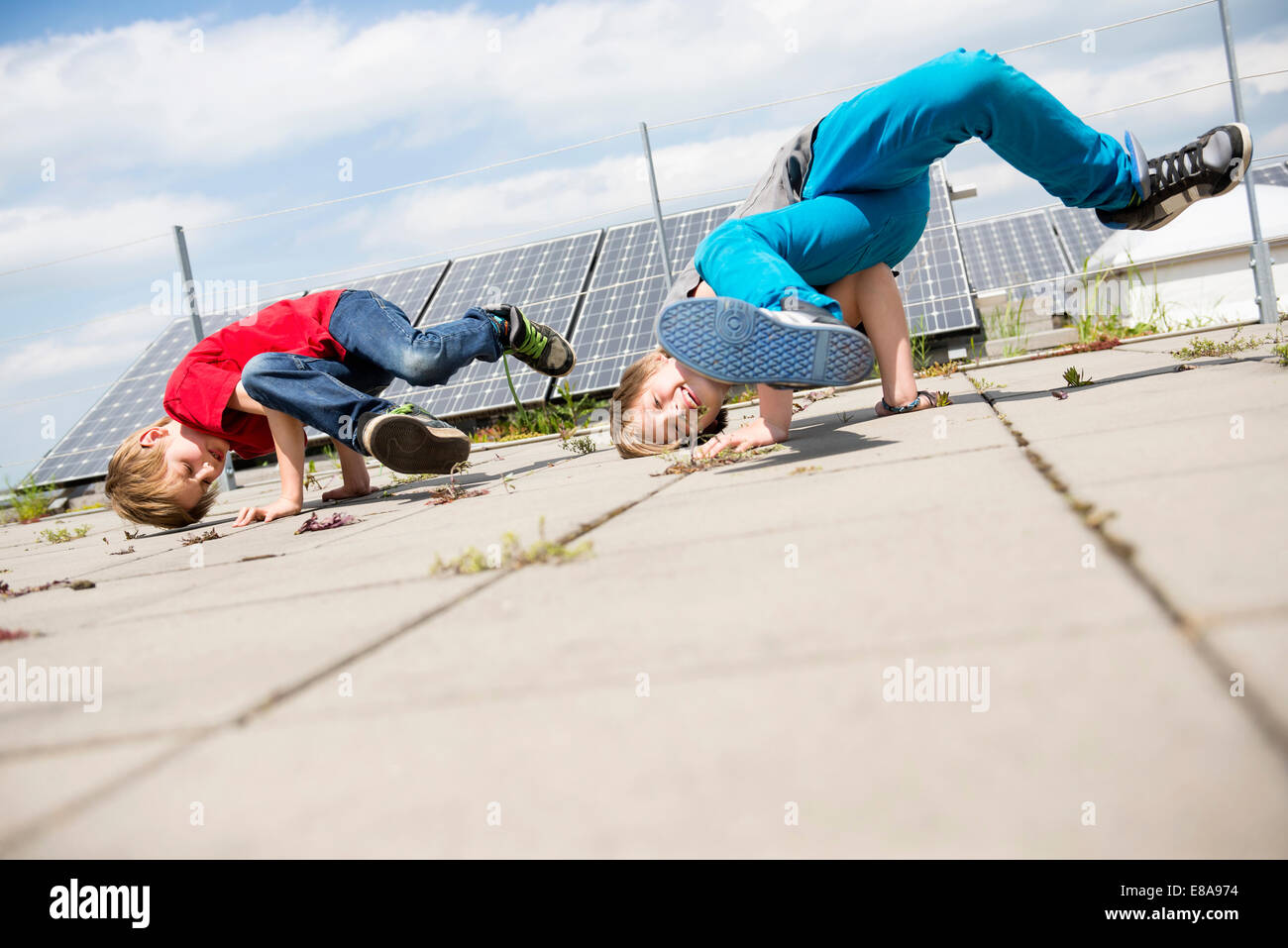Boys brothers break dancing solar park Stock Photo