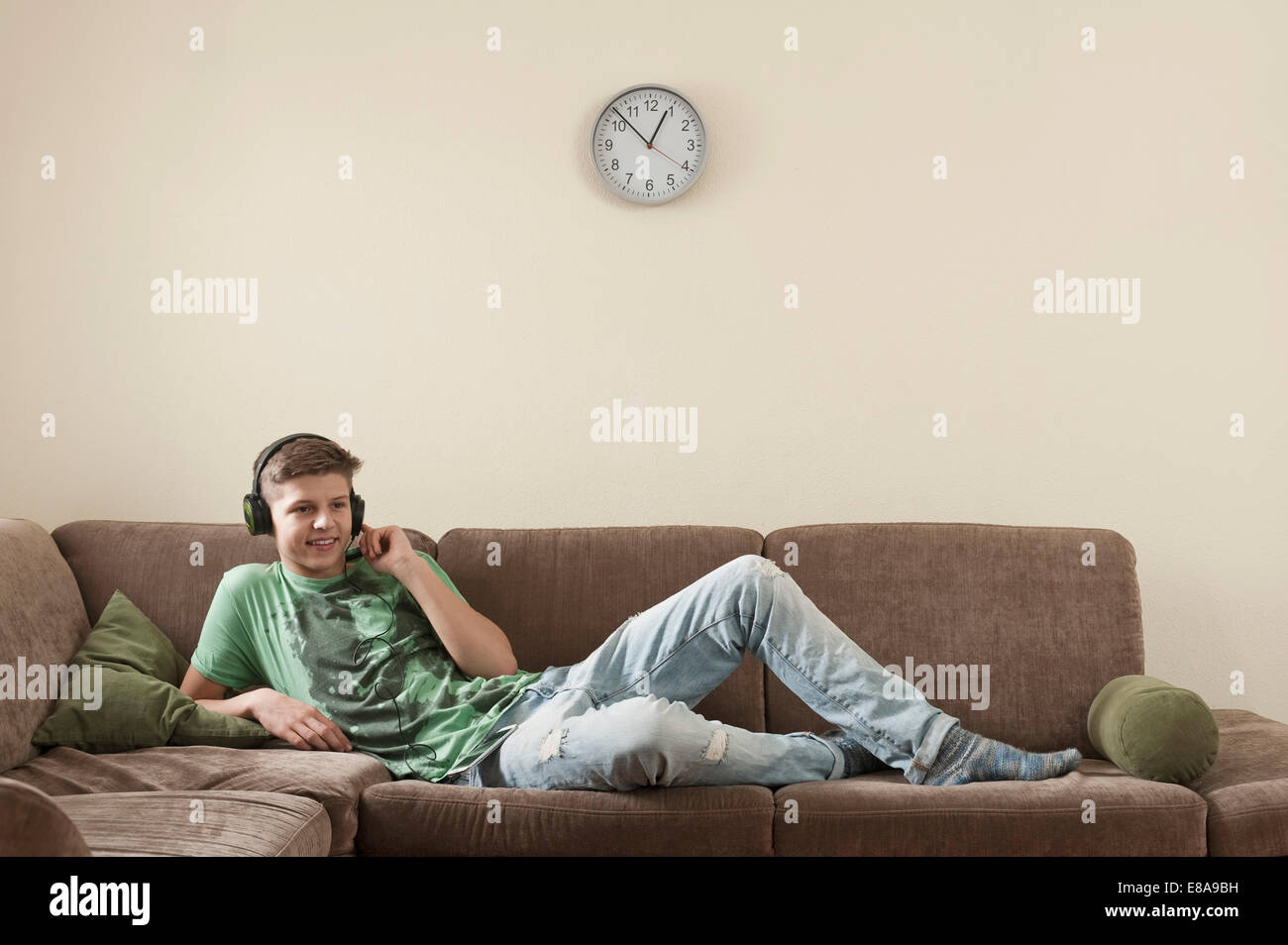 Teenage boy listening music at home Stock Photo