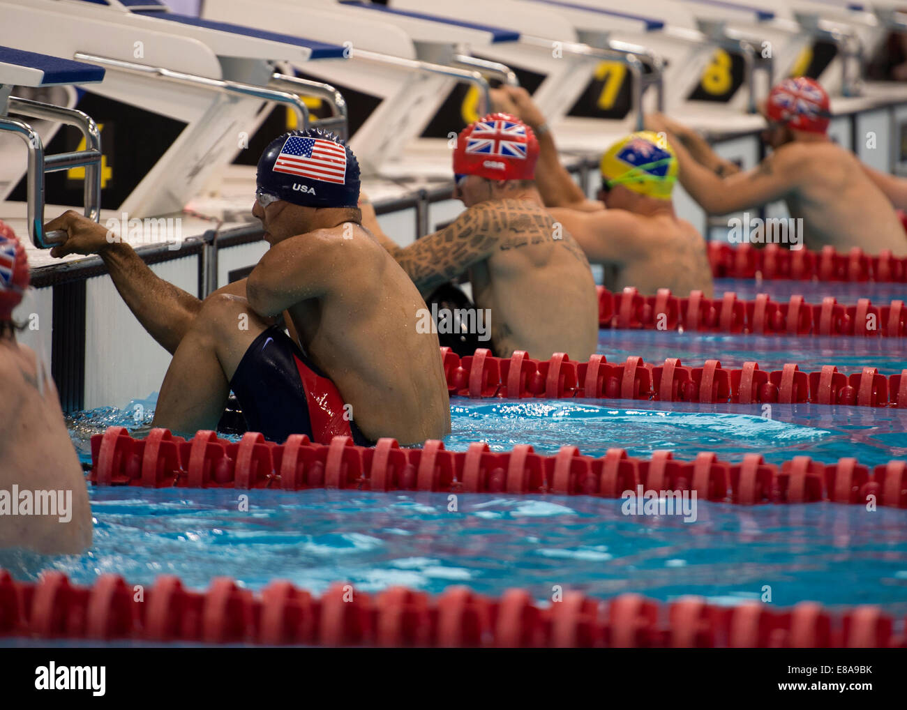 Retired U.S. Army Staff Sgt. Michael Kacer, left, prepares for the 50-meter backstroke race during the swimming portion of the Invictus Games 2014 in London Sept. 14, 2014. The Invictus Games are the United Kingdom's version of the Warrior Games, bringing Stock Photo