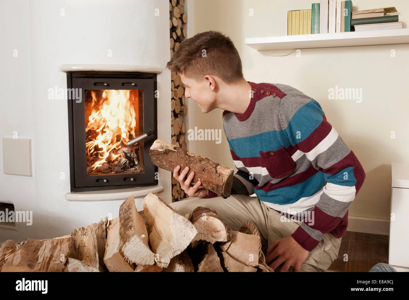 Boy holding firewood hi-res stock photography and images - Alamy