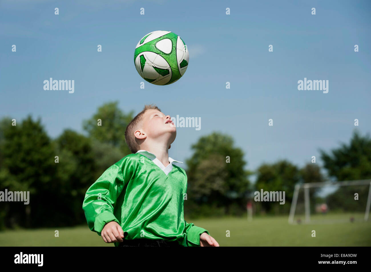 Young boy soccer practice football header ball Stock Photo Alamy