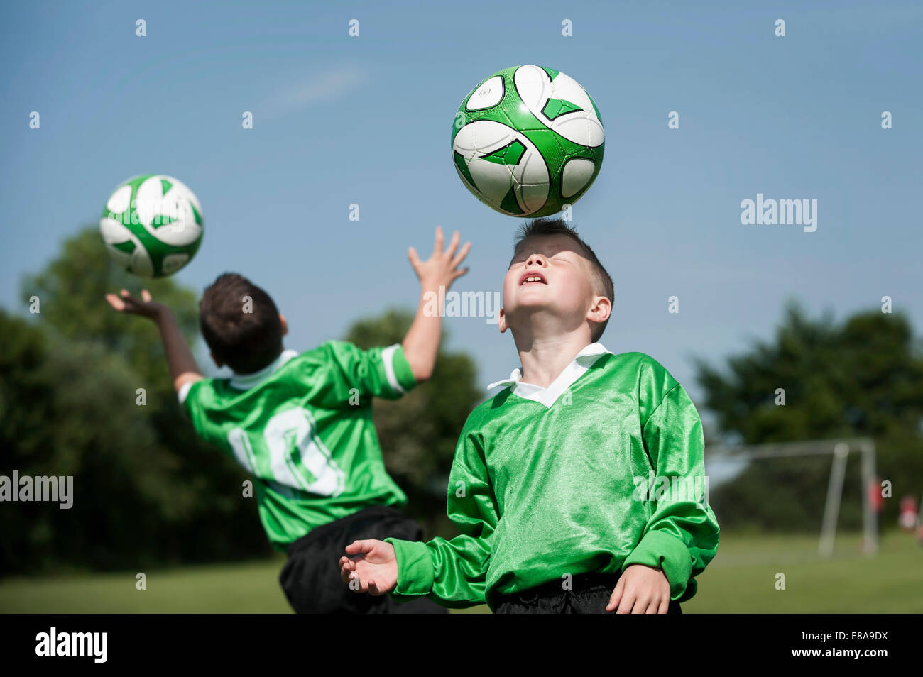 Two young football players learning ball control Stock Photo