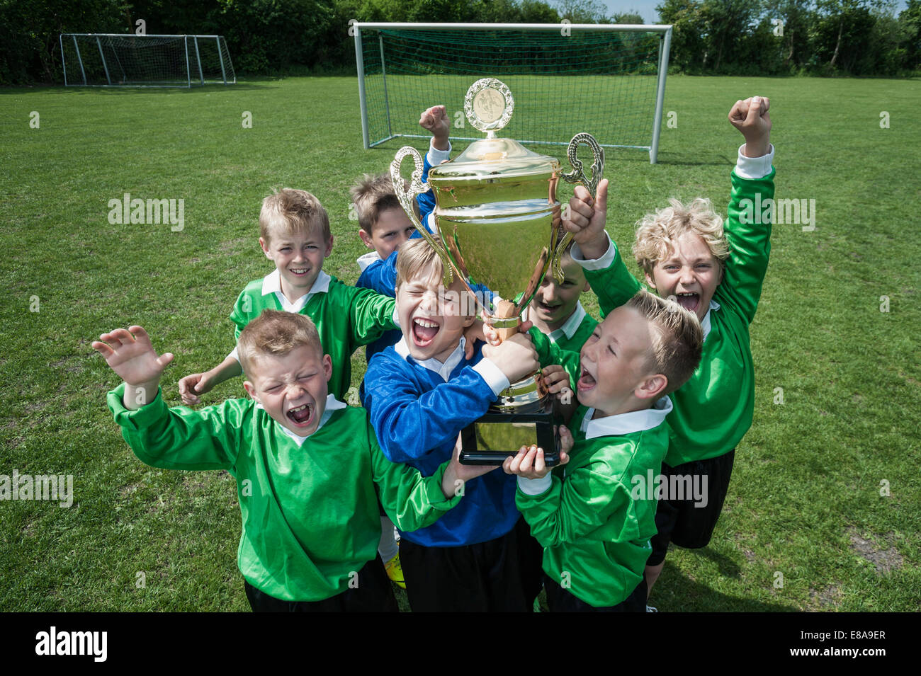 Young boys soccer team holding winners cup Stock Photo
