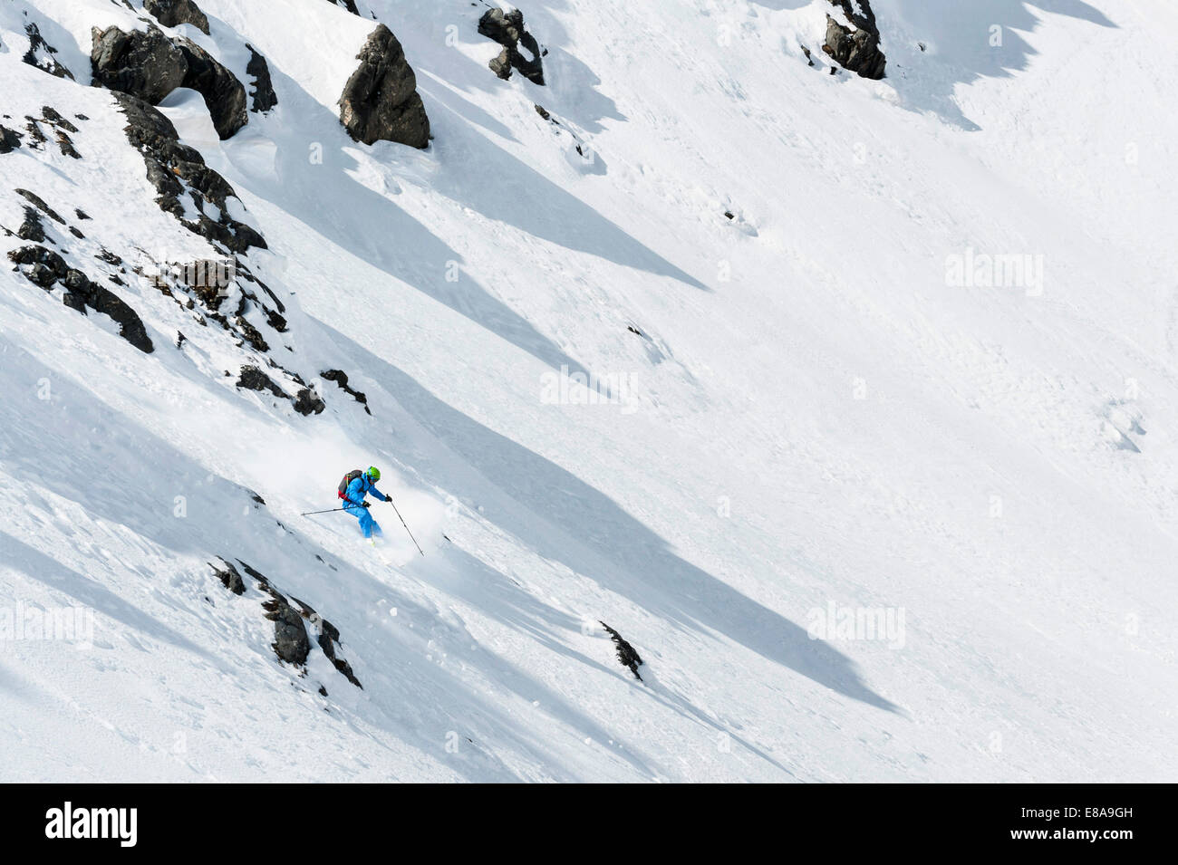Man skiing downhill steep ski slope Alps Stock Photo Alamy
