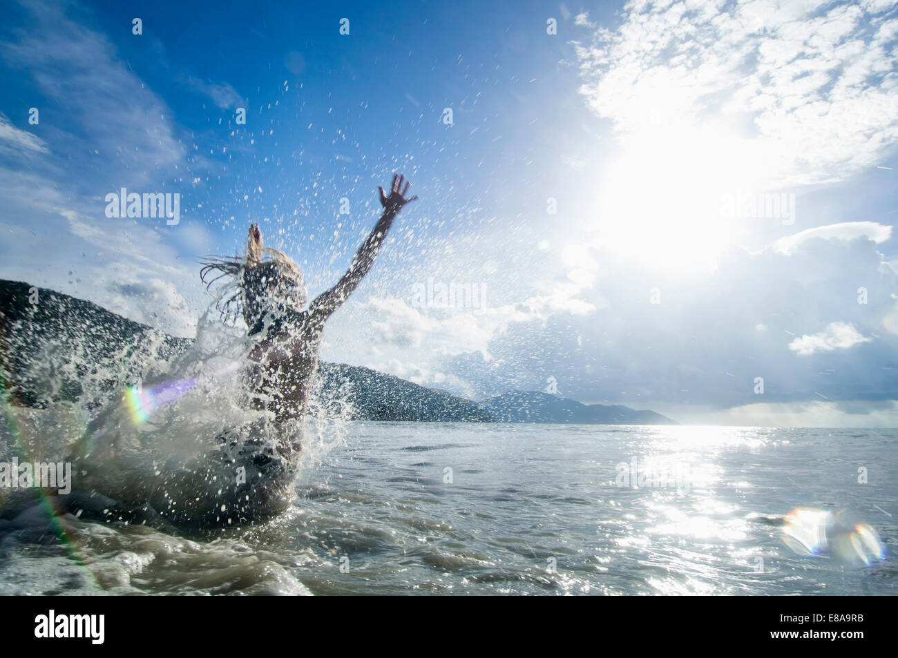 woman jumping into the ocean, Penang, Malaysia Stock Photo Alamy