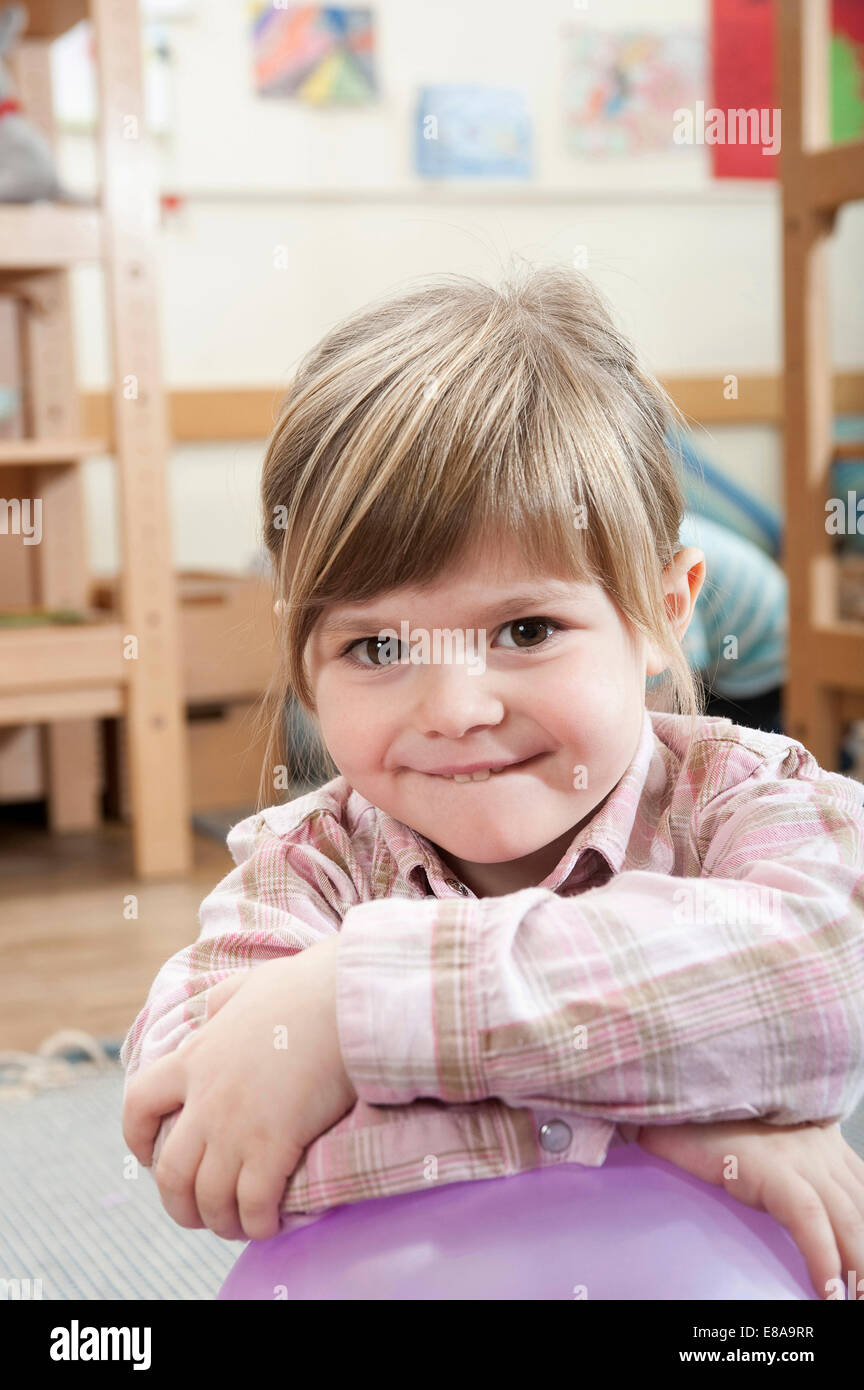Portrait of smiling little girl with crossed arms Stock Photo - Alamy