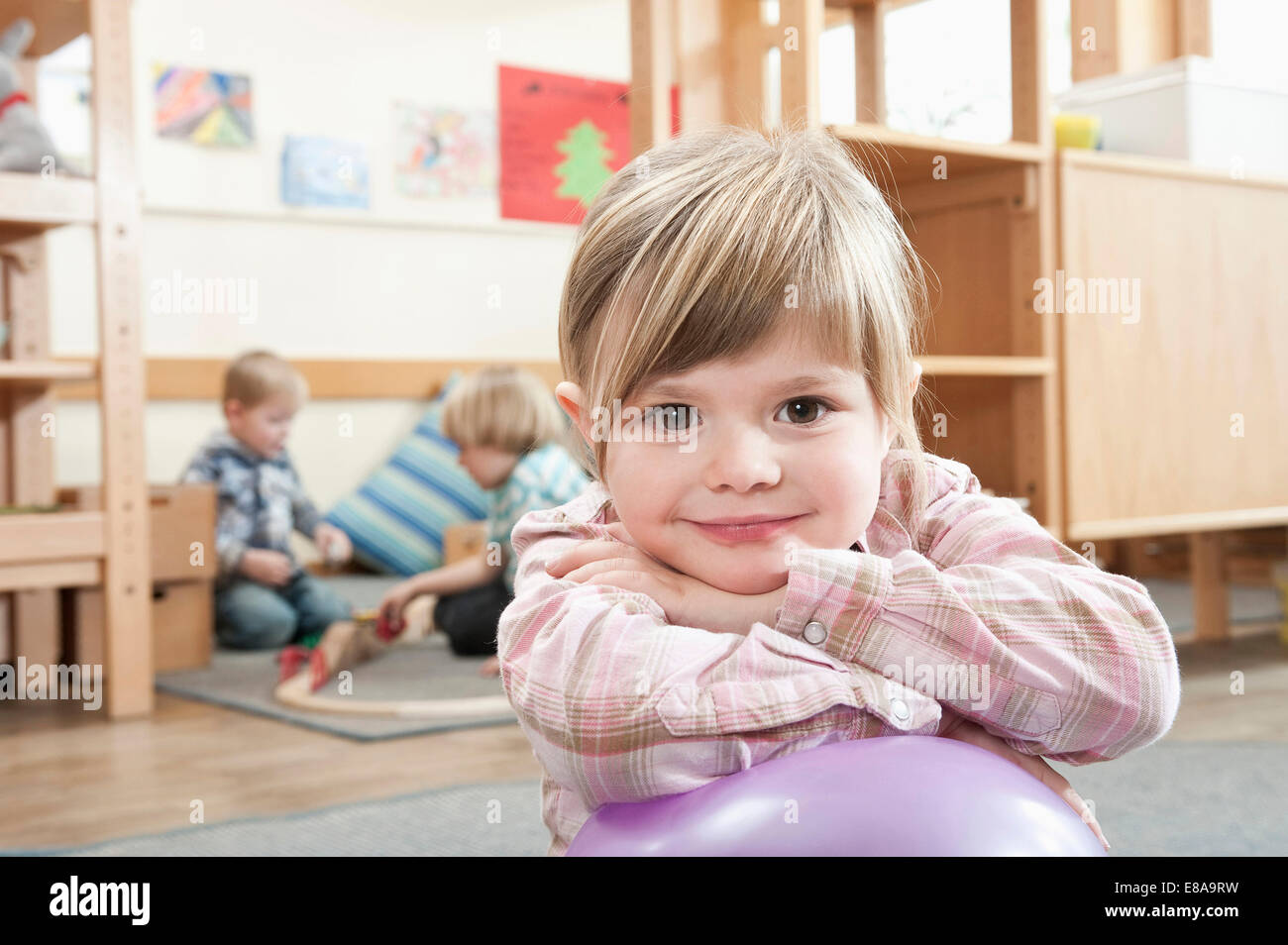 Portrait of smiling little girl with crossed arms Stock Photo - Alamy