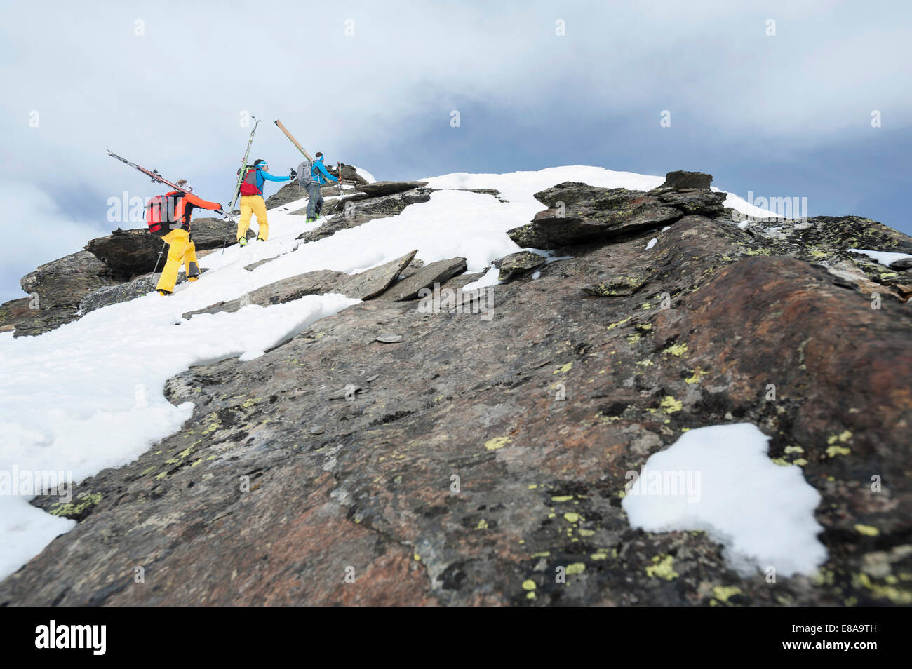 Cross-country skiers climbing mountain rocks Stock Photo