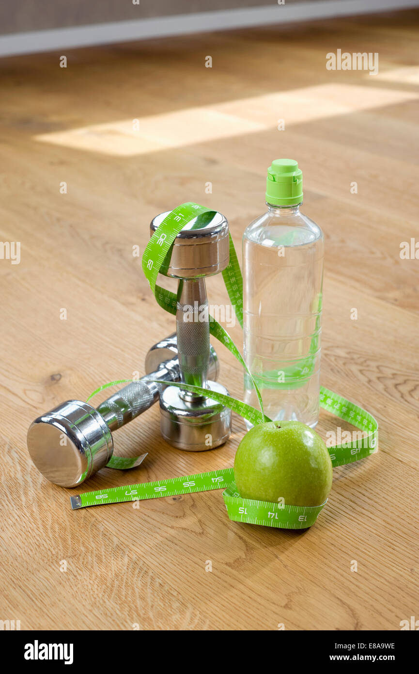 Close up apple barbells water bottle tape measure Stock Photo Alamy