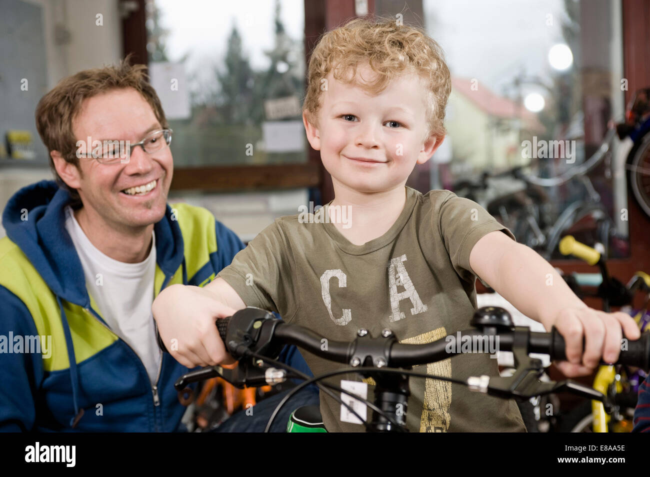 Boy getting a new children's bike Stock Photo Alamy
