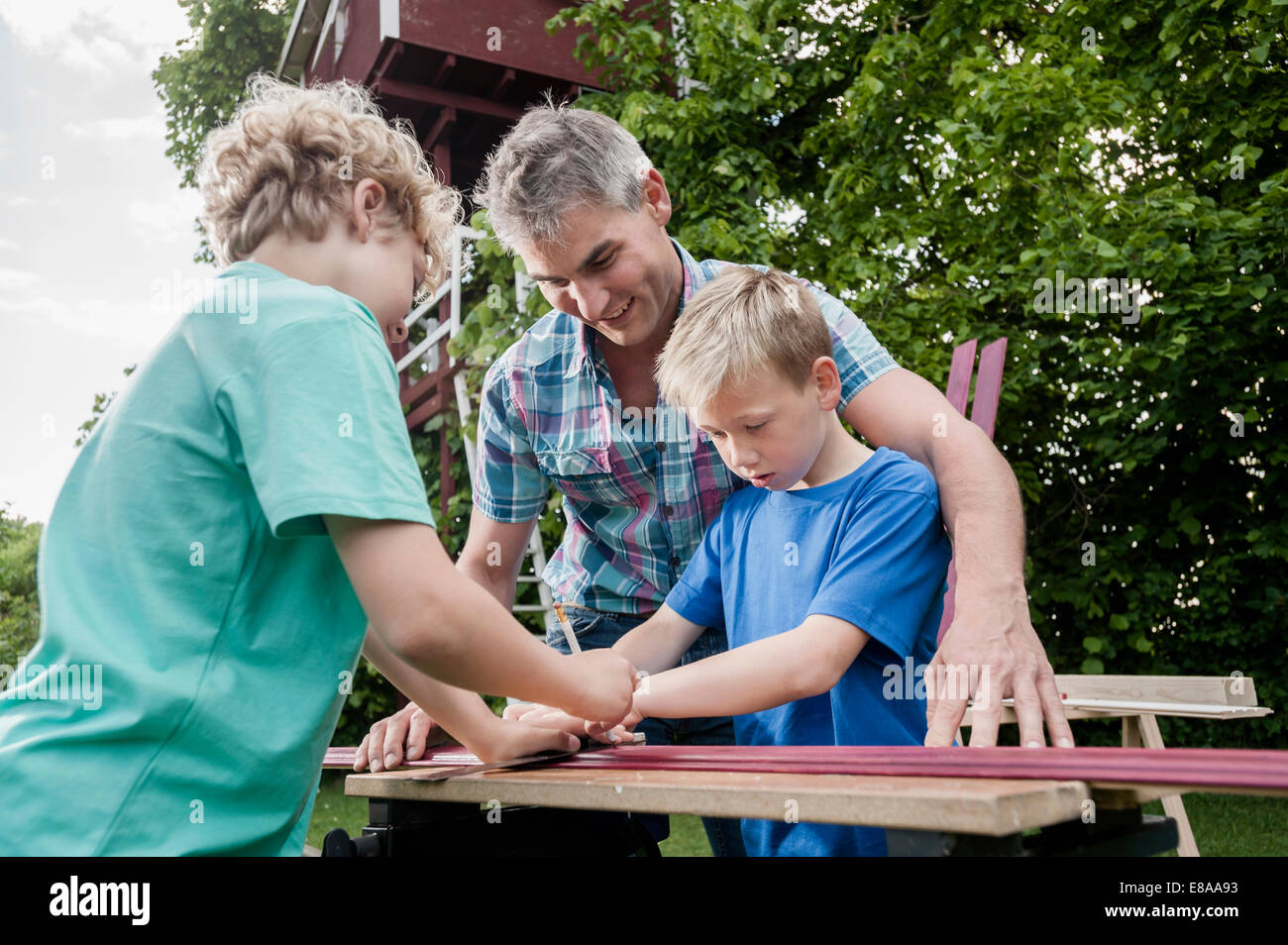 Teamwork father sons wood working building Stock Photo