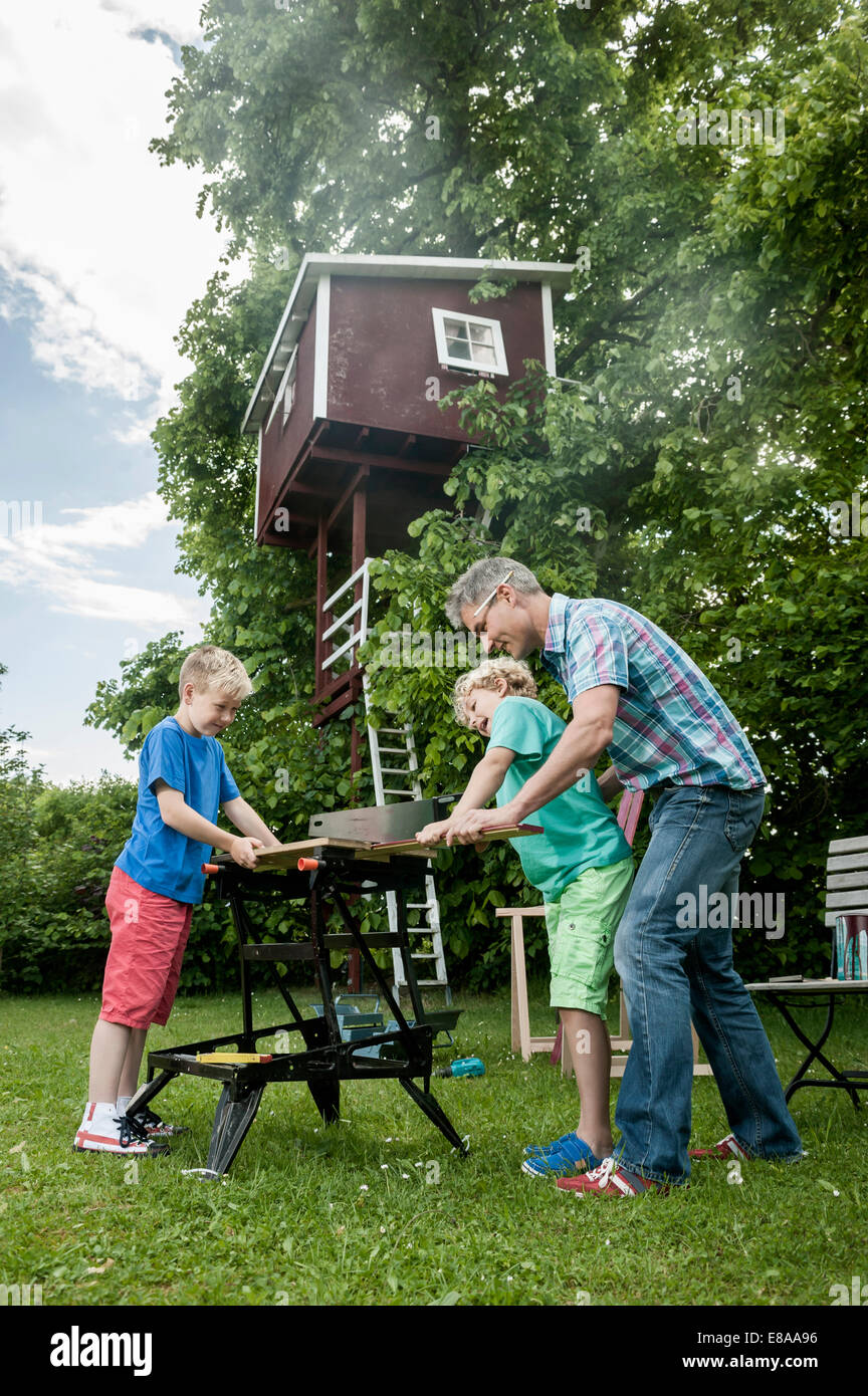Working building father sons garden tree-house Stock Photo